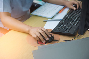 Woman hand on the mouse working in office. Business concept. 
