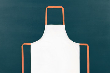 Closeup of white apron on black chalkboard background