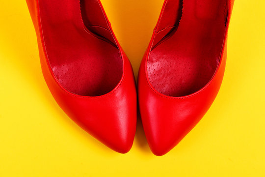 Red High Heel Shoes On Juicy Yellow Background