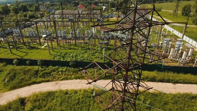 Aerial view Power plant, transformation station, cables and wires. High voltage electric power substation. Electrical power transformer in high voltage substation, 4K, aerial footage.