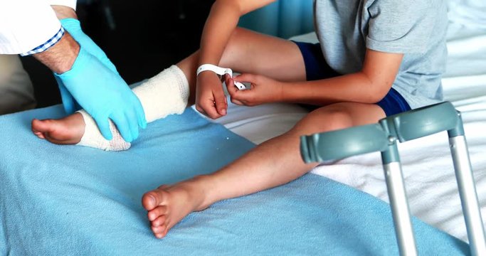 Male doctor examining patient leg