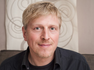 Portrait of a mature smiling man at home