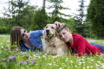 Mother, son and dog playing

