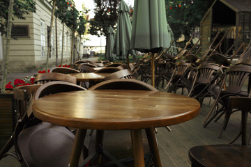 Empty chairs and tables near the summer cafe