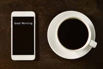 cup of coffee and smartphone on the wood