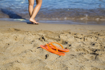 Pair of flip flops on sand beach