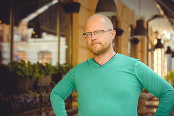 Fototapeta na wymiar Portrait mature writer hipster man, with red beard walk at the European city 