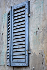 shutters closed on an old italian wall