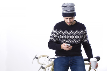 Man hipster sitting on bicycle using cellphone