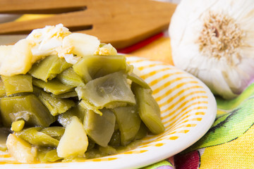 Plate of green beans cooked on the table