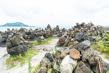 Fototapeta na wymiar stone towers on basaltic rocks at Hyeopjae Beach,Jeju Island