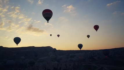 Flying hot air balloons over the valley, sunrise aerial view