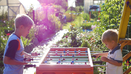 children playing table football outdoors.Fun outdoors