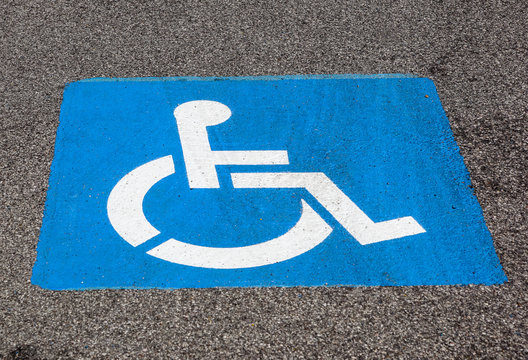 Disability symbol painted on the floor at parking lot