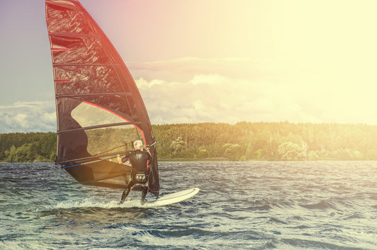 Windsurfer Surfing The Wind On Waves, Recreational Water Sports, Extreme Sport Action. Recreational Sporting Activity. Healthy Active Lifestyle. Summer Fun Adventure. Hobby
