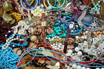 Jumble of costume jewelry: necklaces, bracelets and earrings.