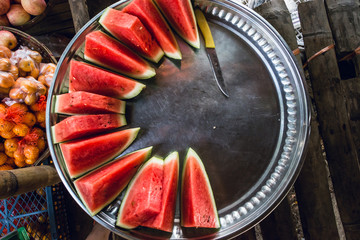 Watermelon slices in a street vendor's plate in a Burmese town near Yangon