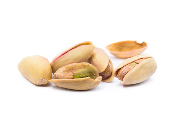 Pile of roasted pistachios isolated on white background