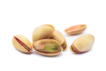 Pile of roasted pistachios isolated on white background