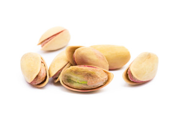 Pile of roasted pistachios isolated on white background