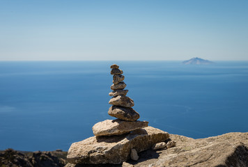 Fototapeta na wymiar Pebbles with at view to Montecristo Island