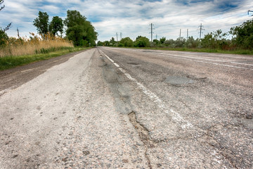 Background texture landscape old road highway with holes in the summer of HDR