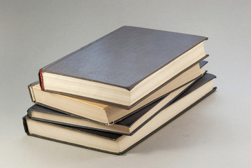 Old books with redened pages are stacked