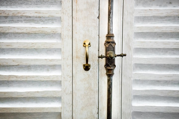 detail of old window lock and handle made of brass