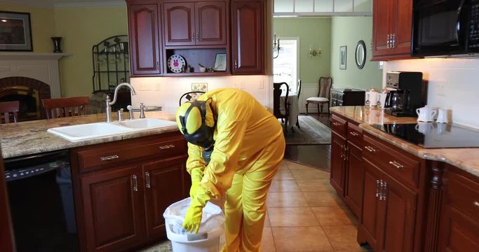Woman in haz mat taking out garbage