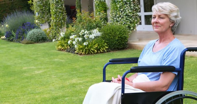 Thoughtful senior woman sitting in wheelchair