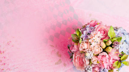 a bouquet of flowers on a pink background in style shabby chic.