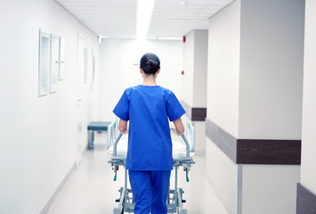 nurse carrying hospital gurney to emergency room
