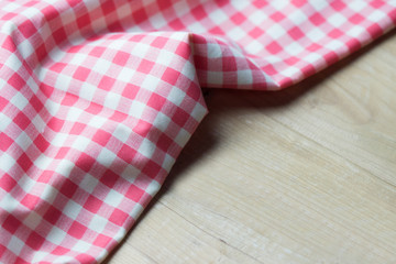 Fototapeta premium Close up red napkin on wooden table. copy space