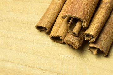 Close up group of cinnamon stick on top right wooden table. macro