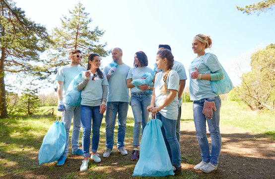 volunteers with garbage bags walking outdoors