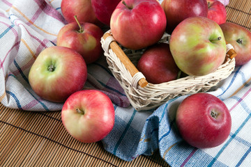 Still life of many apples on a napkin in the basket