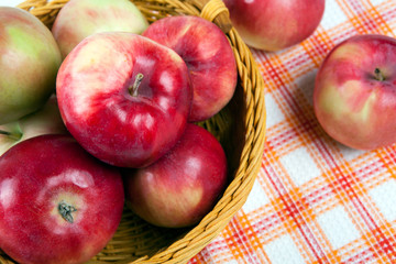 Still life of many apples on a napkin in the basket