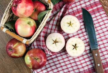 Still life of many apples on a napkin in the basket on a napkin