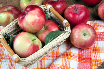 Still life of many apples on a napkin in the basket on a napkin