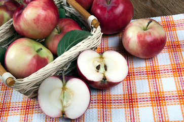 Still life of many apples on a napkin in the basket on a napkin