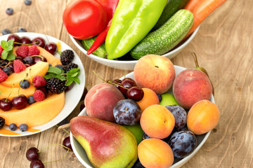 Fresh organic food - fruit and vegetable in bowl on table