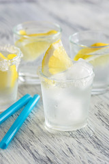 Cold drink with lemon and ice. Cool lemonade.