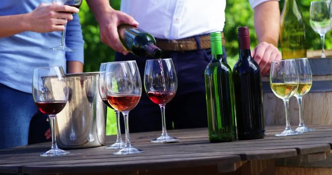 Happy man pouring wine in glass
