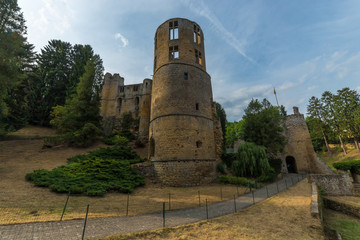 Medieval castle among trees and blue sky in Luxembourg