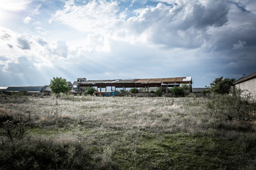 An abandoned building for drying grain on the background of an evening overcast sky