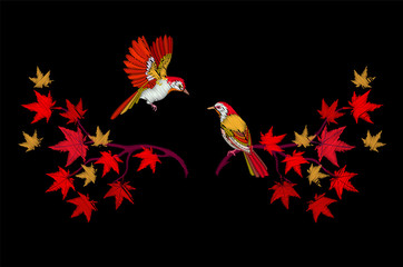 Embroidery of a bird on the branches of a maple.