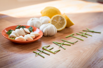Fototapeta na wymiar Mix of vegetables garlic lemon and parsley on a table for preparing healthy diet receipt