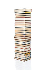 High stack of various books stacked one on another, isolated on white background
