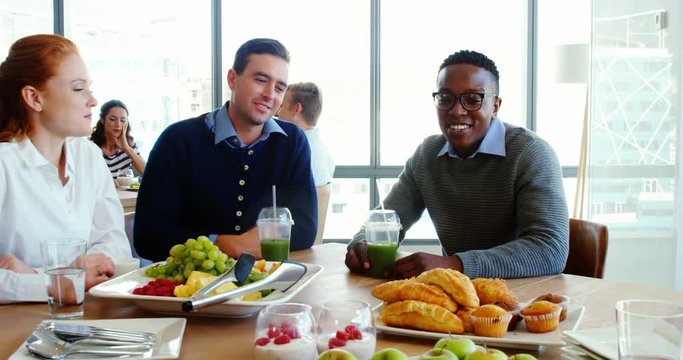 African American executives interacting while having meal