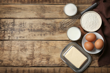 Ingredients for butter cake on wooden table